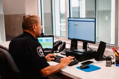 Police Officer using Athena Records Management System